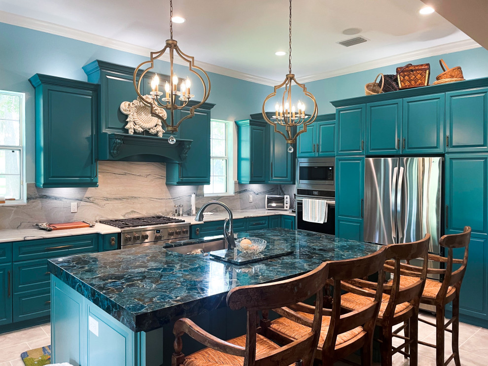 Eclectic l-shaped porcelain tile and gray floor kitchen photo in Tampa with an undermount sink, raised-panel cabinets, turquoise cabinets, quartz countertops, white backsplash, quartz backsplash, stainless steel appliances, an island and white countertops