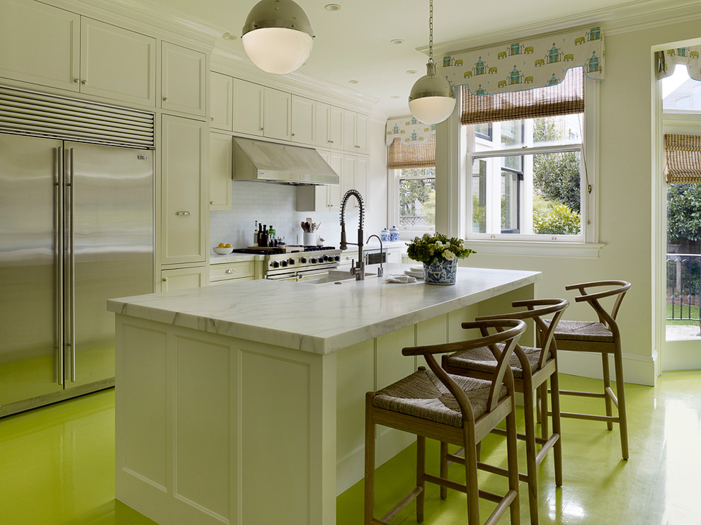 This is an example of a contemporary kitchen in San Francisco with stainless steel appliances, painted wood floors and green floor.