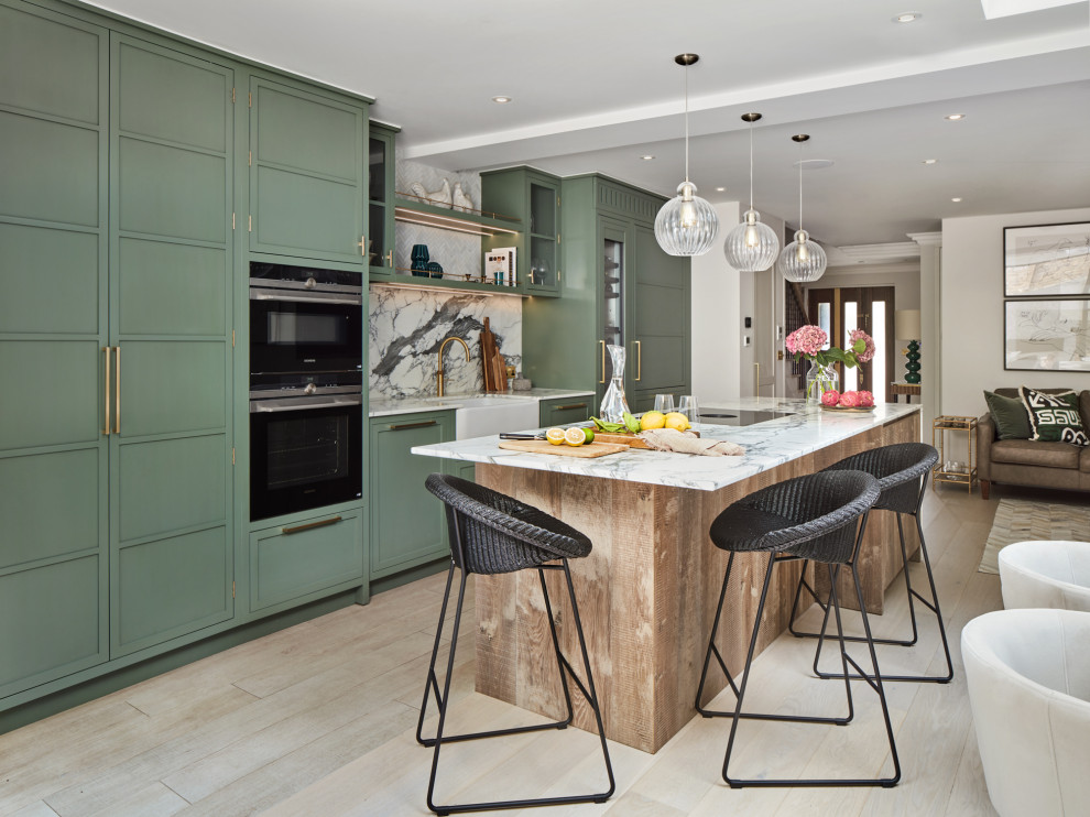Design ideas for a mid-sized transitional single-wall open plan kitchen in London with light hardwood floors, beige floor, a drop-in sink, flat-panel cabinets, green cabinets, yellow splashback, marble splashback, coloured appliances, with island and white benchtop.