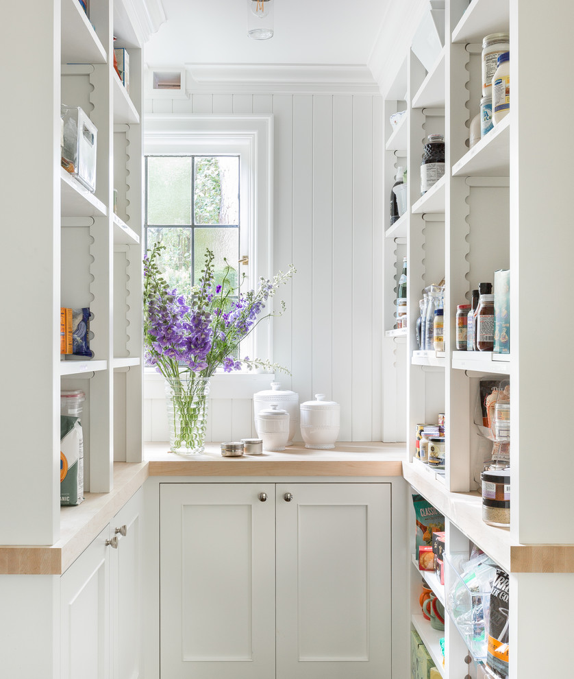 This is an example of a traditional u-shaped kitchen pantry in Seattle with open cabinets, white cabinets, wood benchtops and white splashback.