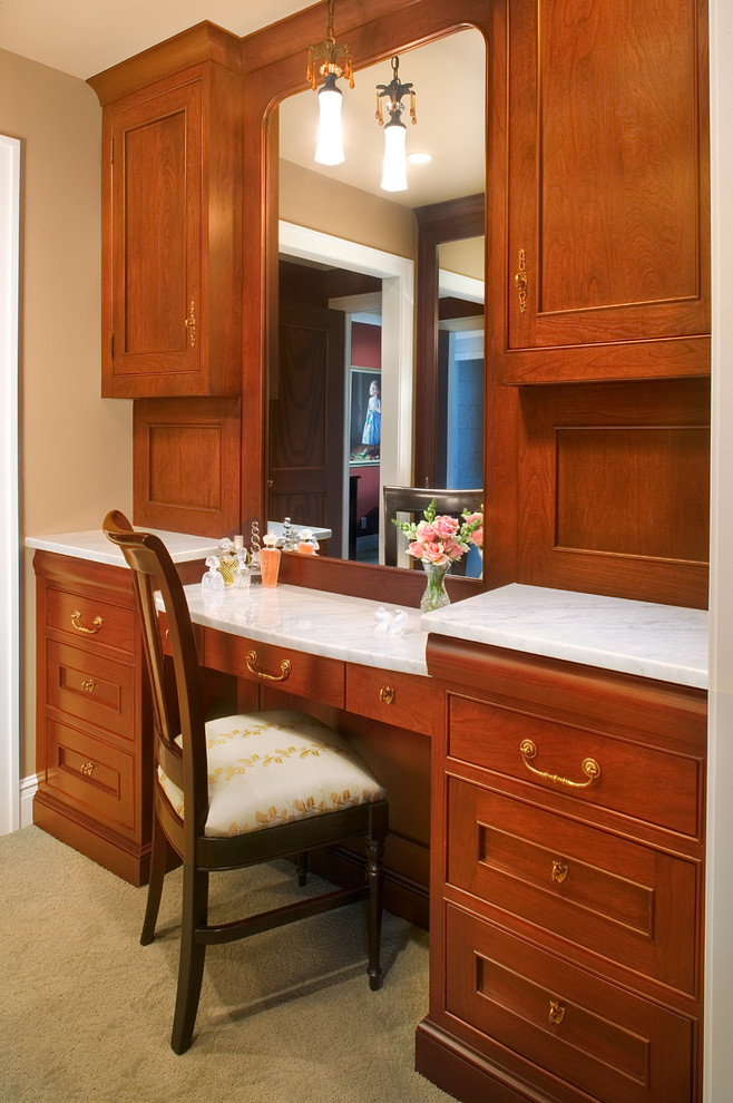 Inspiration for a large traditional dressing room in Grand Rapids with beaded inset cabinets, medium wood cabinets and carpet.