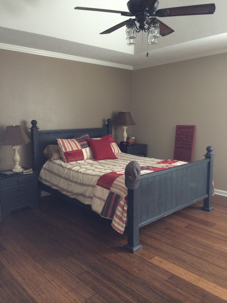 Large country master bedroom in Kansas City with beige walls and bamboo floors.