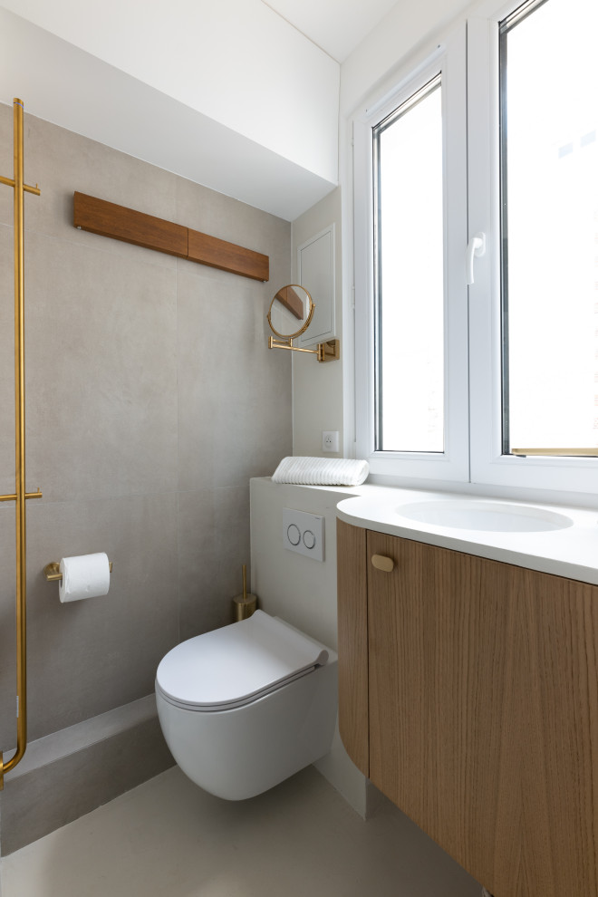 Exemple d'une petite salle d'eau beige et blanche moderne avec un placard à porte affleurante, des portes de placard marrons, une douche d'angle, WC suspendus, un carrelage beige, un mur blanc, sol en béton ciré, un lavabo encastré, un plan de toilette en béton, un sol beige, une cabine de douche à porte battante, un plan de toilette beige, une fenêtre, meuble simple vasque et meuble-lavabo suspendu.