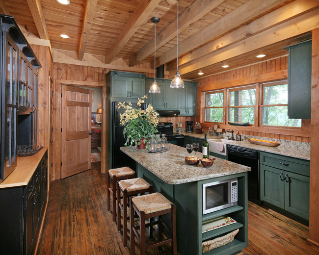 This is an example of a large traditional u-shaped eat-in kitchen in Atlanta with a farmhouse sink, recessed-panel cabinets, green cabinets, granite benchtops, brown splashback, black appliances and with island.
