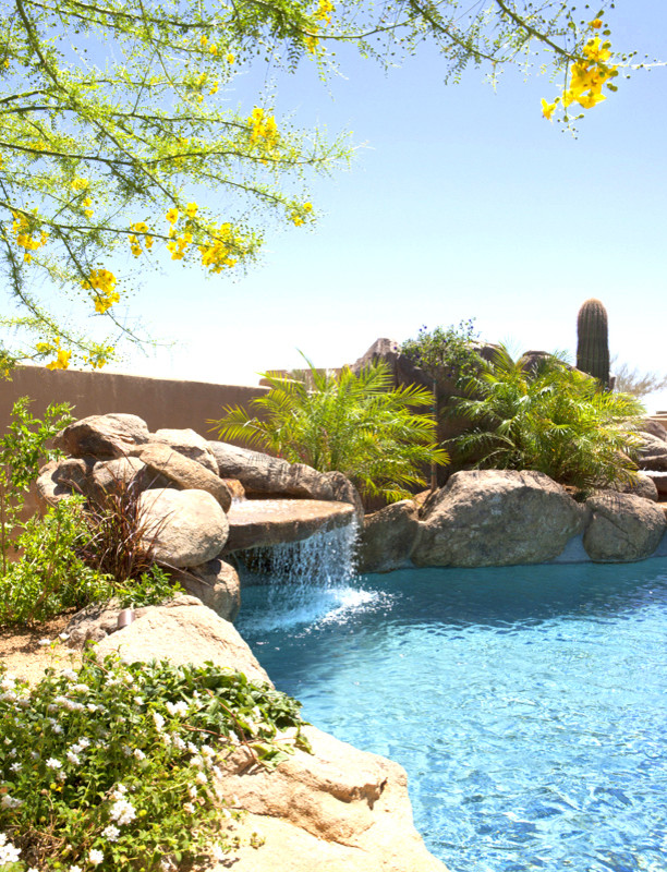 Inspiration for a rustic backyard concrete paver and custom-shaped natural pool fountain remodel in Phoenix