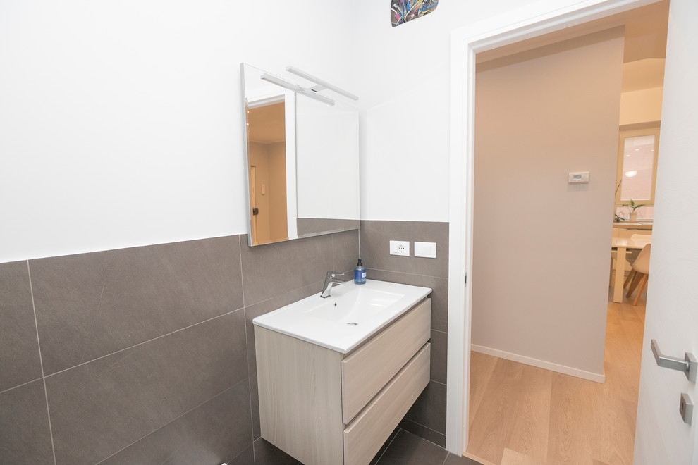 Mid-sized contemporary 3/4 bathroom in Other with furniture-like cabinets, beige cabinets, an open shower, brown tile, porcelain tile, white walls, porcelain floors, a drop-in sink, solid surface benchtops, brown floor and a sliding shower screen.