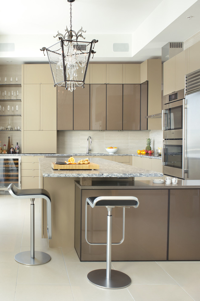 Eat-in kitchen - large contemporary l-shaped porcelain tile and beige floor eat-in kitchen idea in Other with flat-panel cabinets, beige cabinets, quartz countertops, beige backsplash, porcelain backsplash, stainless steel appliances, an island and an undermount sink