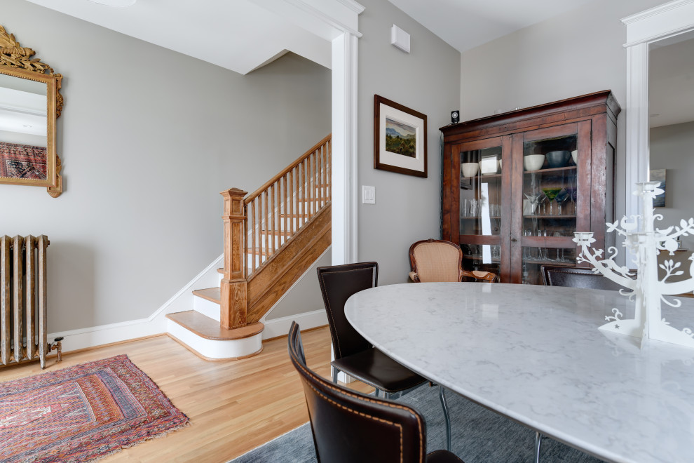 Inspiration for a mid-sized transitional medium tone wood floor foyer remodel with gray walls and a white front door