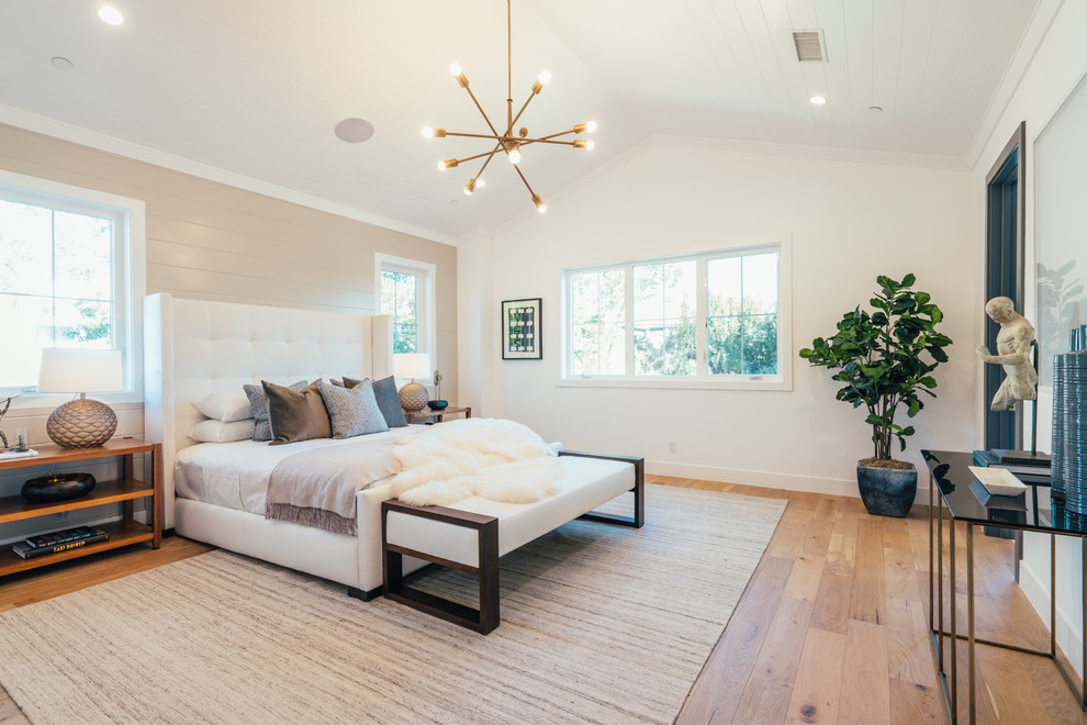 Beach style master bedroom in Los Angeles with white walls, light hardwood floors, no fireplace and beige floor.