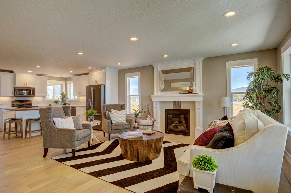 Mid-sized transitional open concept living room in Salt Lake City with beige walls, light hardwood floors, a standard fireplace, a tile fireplace surround and no tv.