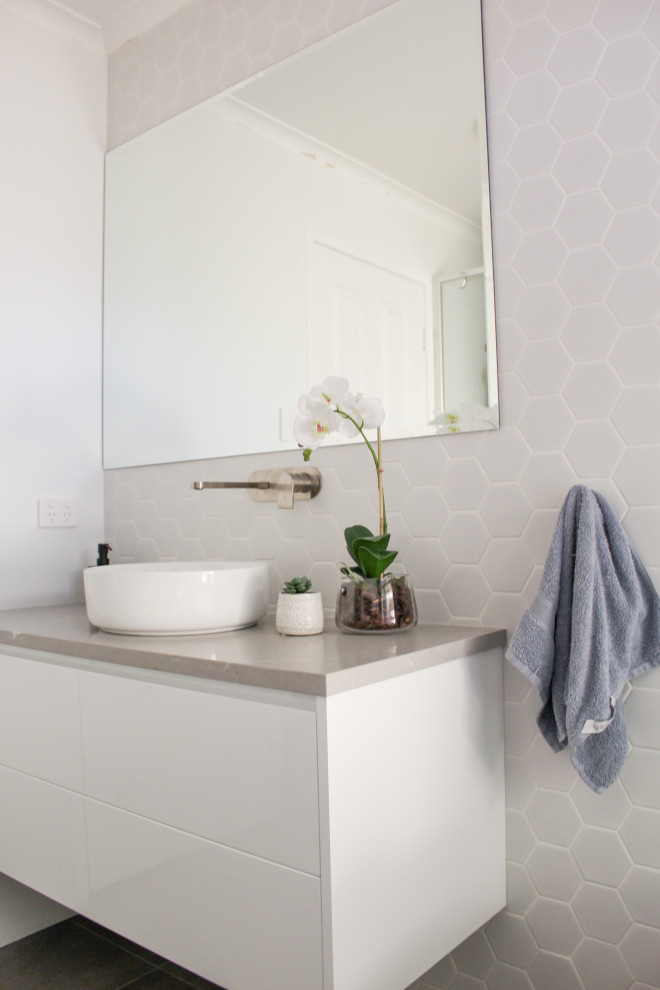 This is an example of a mid-sized modern 3/4 bathroom in Perth with flat-panel cabinets, white cabinets, a freestanding tub, an alcove shower, white tile, mosaic tile, porcelain floors, a vessel sink, engineered quartz benchtops, grey floor, a hinged shower door, grey benchtops, a single vanity and a floating vanity.