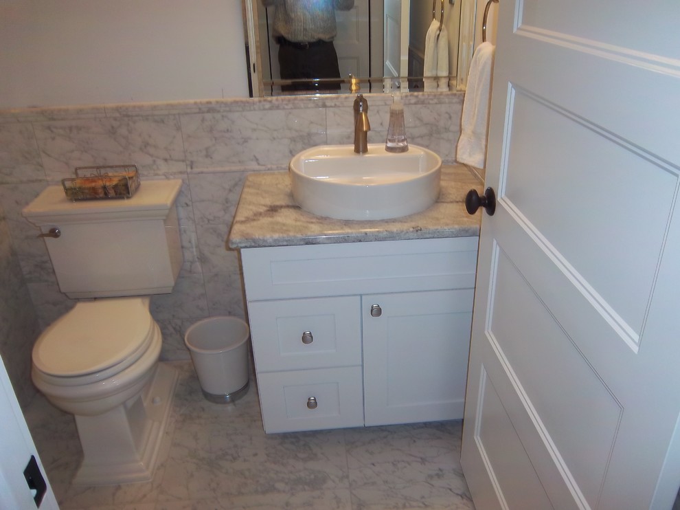 This is an example of a small transitional powder room in Other with shaker cabinets, white cabinets, a two-piece toilet, white tile, marble, white walls, marble floors, a vessel sink, granite benchtops and white floor.