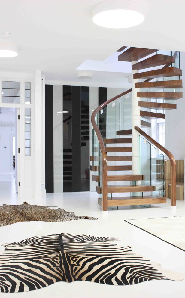 Contemporary wood staircase in London with open risers.