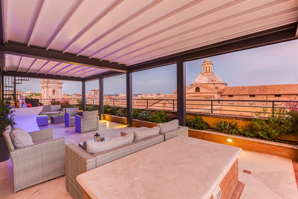 Photo of an expansive contemporary rooftop and rooftop deck in Rome with a roof extension.