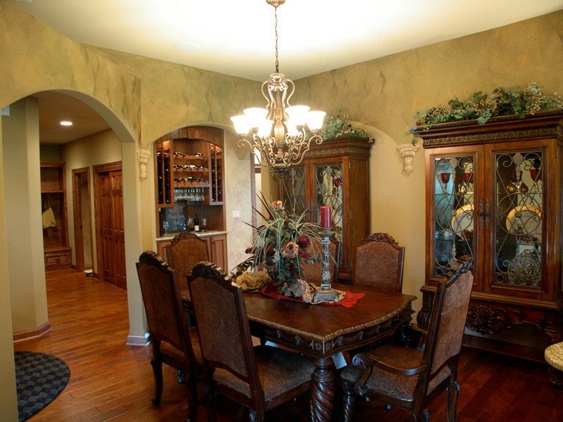 Photo of a mid-sized traditional separate dining room in Milwaukee with beige walls and dark hardwood floors.