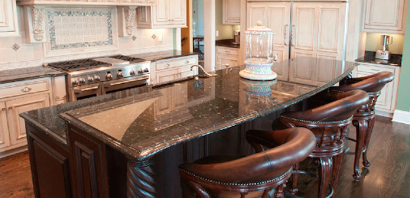 Example of a medium tone wood floor eat-in kitchen design with a double-bowl sink, recessed-panel cabinets, granite countertops, an island and stainless steel appliances
