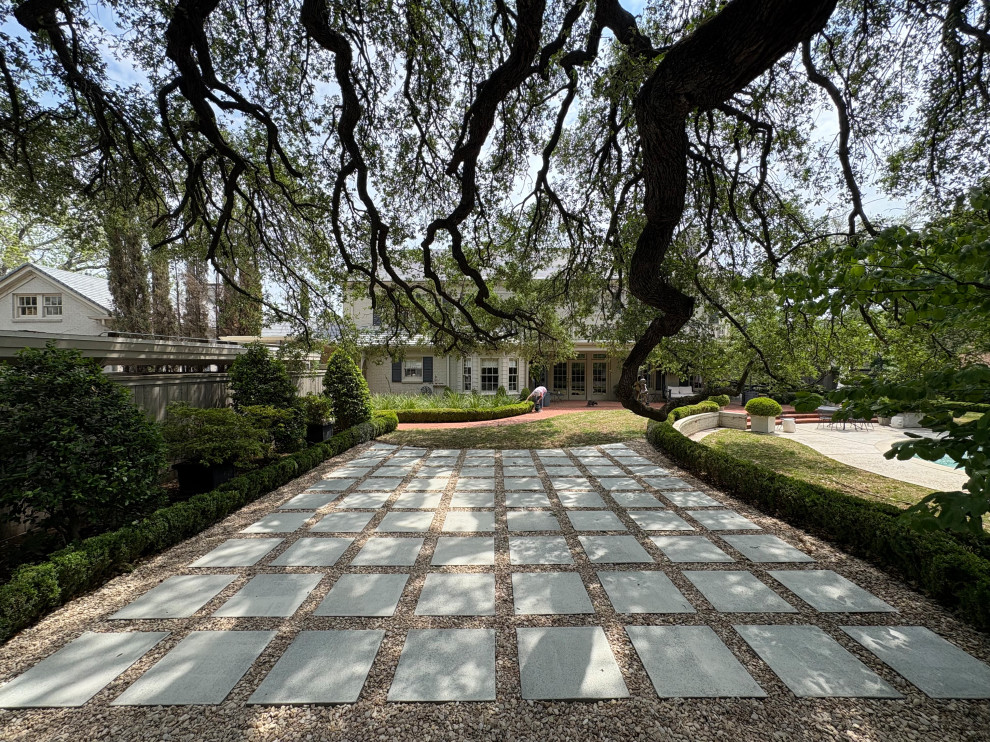 Photo of a large shade backyard concrete paver landscaping in Austin.