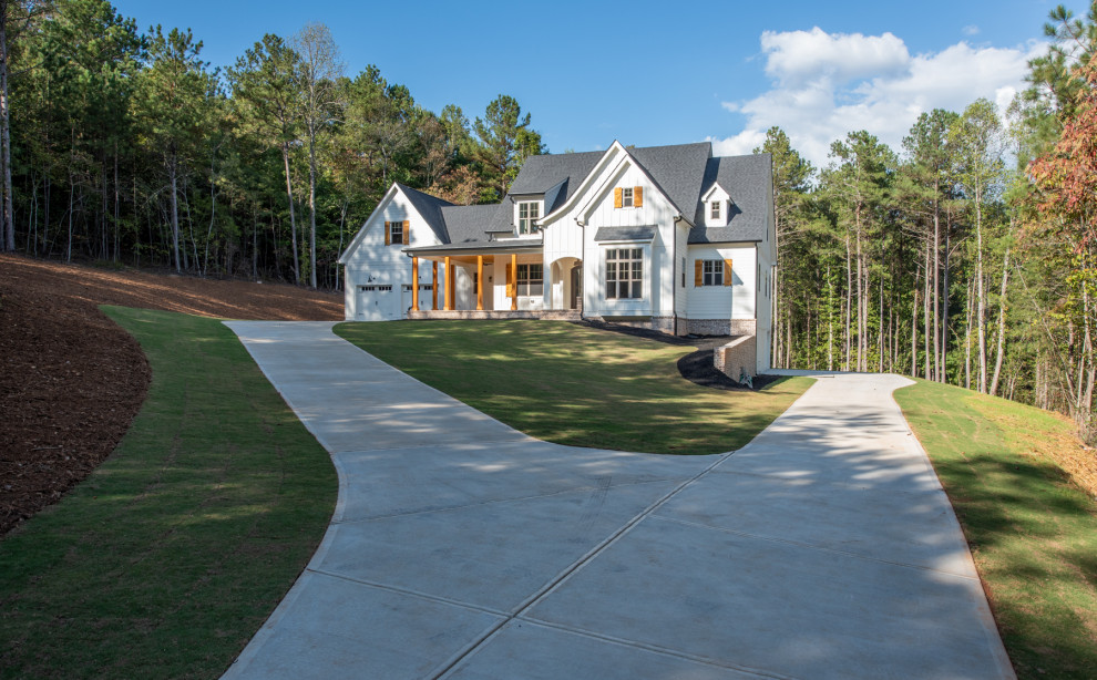 Photo of a large country three-storey white house exterior in Atlanta with wood siding, a hip roof and a shingle roof.