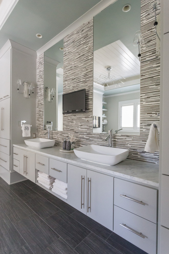 Beach style bathroom in Charleston with flat-panel cabinets, grey cabinets, gray tile, matchstick tile, a vessel sink, grey floor, grey benchtops, a double vanity and a built-in vanity.