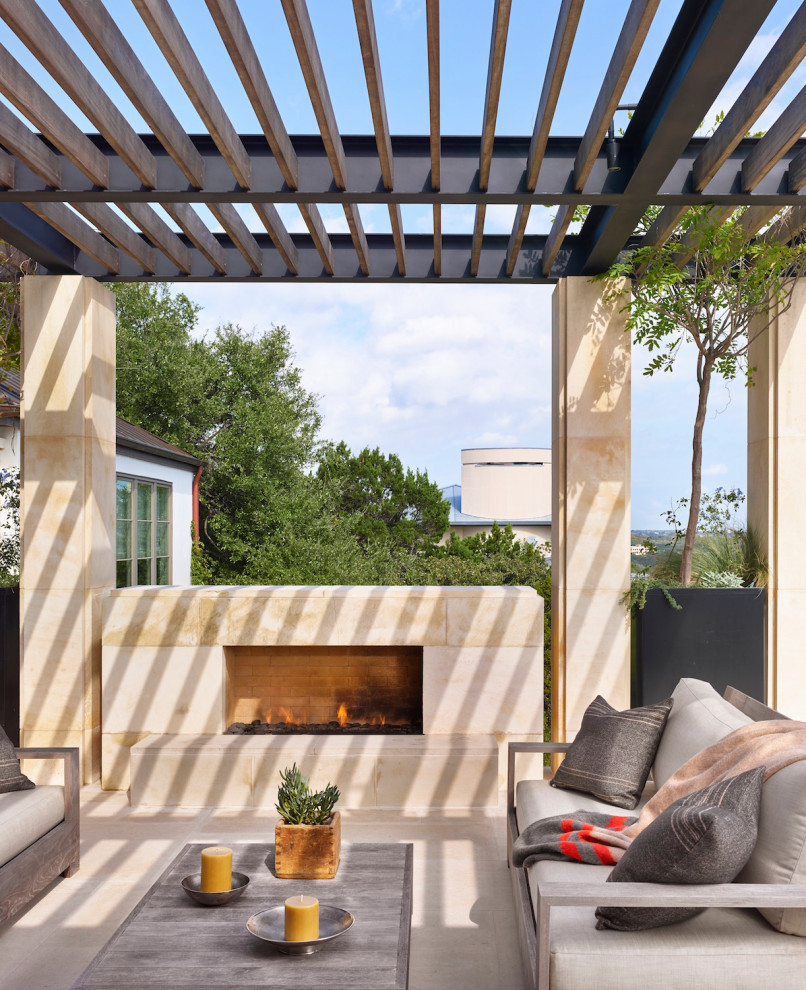 Inspiration for a mid-sized midcentury side yard patio in Austin with with fireplace and a pergola.