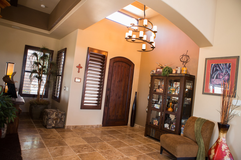 Inspiration for a mid-sized transitional travertine floor foyer remodel in Phoenix with beige walls and a medium wood front door