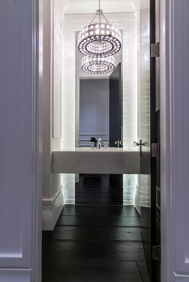 This is an example of a contemporary powder room in Edmonton with a wall-mount sink and dark hardwood floors.