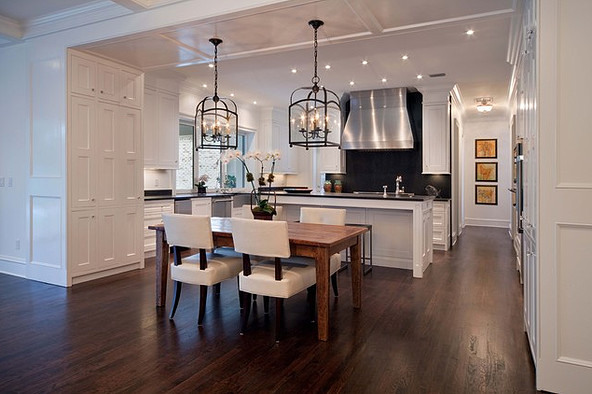 Eat-in kitchen - large transitional galley dark wood floor and brown floor eat-in kitchen idea in Chicago with white cabinets, an island, beaded inset cabinets, quartz countertops, black backsplash, stone slab backsplash and stainless steel appliances
