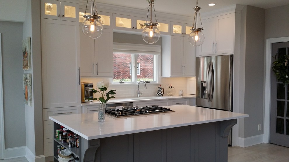 Inspiration for a mid-sized modern l-shaped kitchen in Charlotte with an undermount sink, shaker cabinets, grey cabinets, glass benchtops, white splashback, porcelain splashback, stainless steel appliances, porcelain floors and with island.