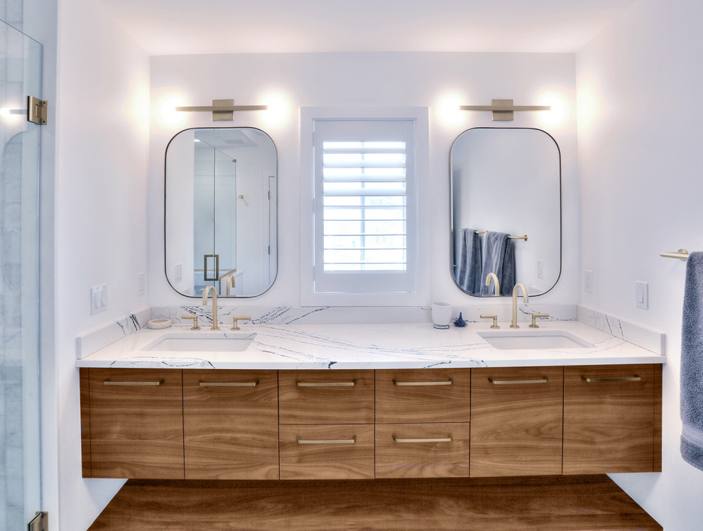 Design ideas for a mid-sized scandinavian master bathroom in Bridgeport with flat-panel cabinets, medium wood cabinets, a corner shower, a one-piece toilet, blue tile, white walls, light hardwood floors, an undermount sink, engineered quartz benchtops, beige floor, a hinged shower door, blue benchtops, an enclosed toilet, a double vanity, a built-in vanity and vaulted.
