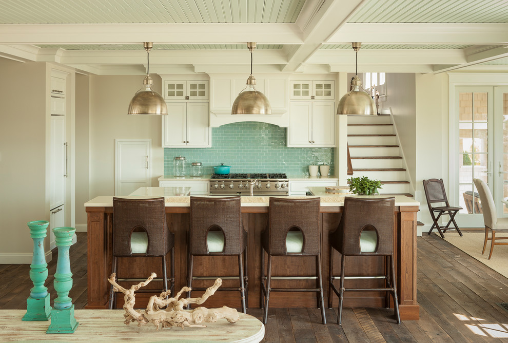 Inspiration for a beach style l-shaped kitchen in Portland Maine with shaker cabinets, white cabinets, blue splashback, subway tile splashback, dark hardwood floors, with island and brown floor.