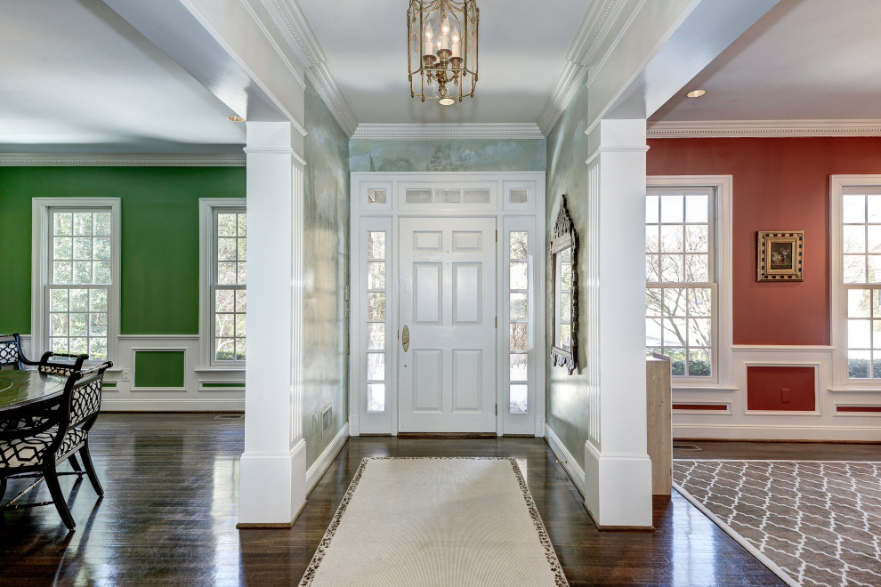 На фото: прихожая среднего размера в классическом стиле с зелеными стенами, темным паркетным полом и одностворчатой входной дверью с