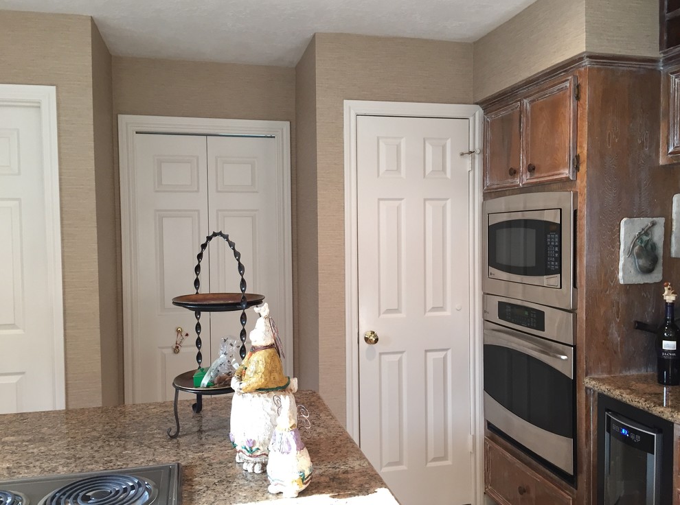 Kitchen - mid-sized transitional kitchen idea in Houston with distressed cabinets, granite countertops and an island