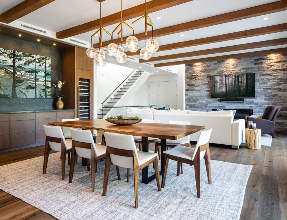 This is an example of a country open plan dining in Vancouver with dark hardwood floors and no fireplace.