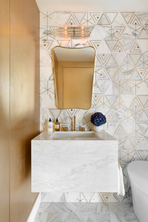 Custom floating marble vanity and stunning white marble with brass inlay tiles finished with gold wallpaper and a vintage sconce make for a dramatic powder bathroom.
Mid-sized trendy white tile and marble tile marble floor, white floor and wallpaper powder room photo in New York with a one-piece toilet, white walls, an undermount sink, marble countertops, white countertops and a floating vanity