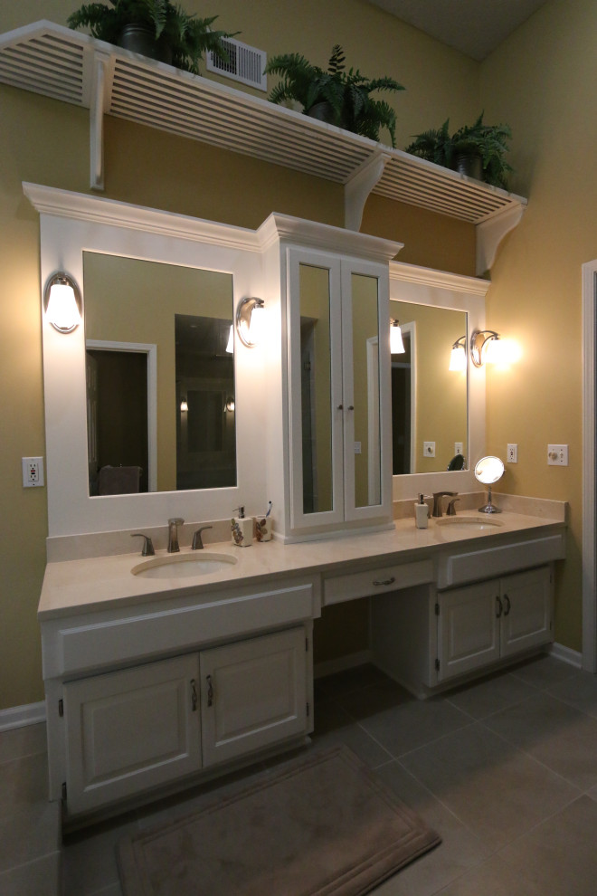 Inspiration for a large traditional master bathroom in Kansas City with raised-panel cabinets, white cabinets, a hot tub, a double shower, porcelain floors, an undermount sink, marble benchtops, brown floor, a hinged shower door, multi-coloured benchtops, a shower seat, a double vanity and a built-in vanity.