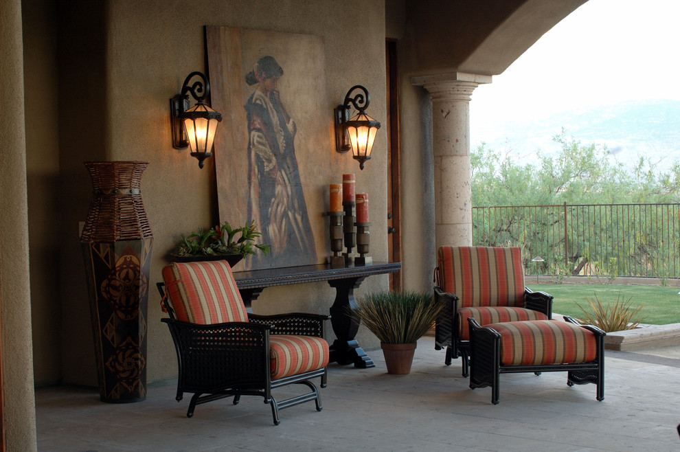 Design ideas for a large traditional backyard patio in Phoenix with natural stone pavers and a roof extension.