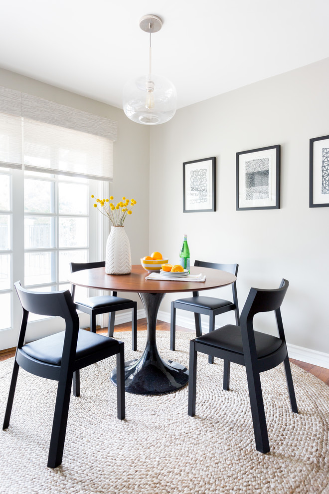 Photo of a transitional dining room in Los Angeles with grey walls and medium hardwood floors.