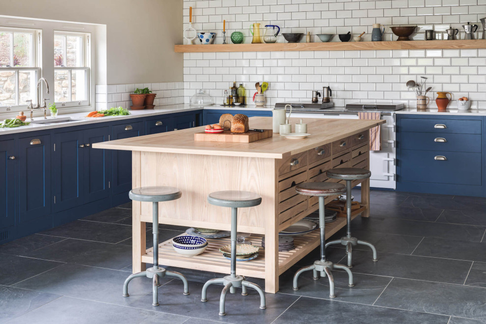 Photo of a large rural l-shaped open plan kitchen in Other with shaker cabinets, blue cabinets and an island.