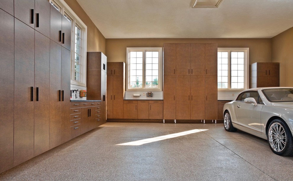 Large trendy attached two-car garage workshop photo in Other