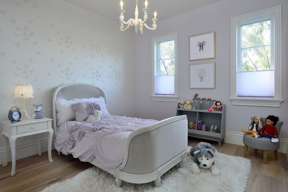 Photo of a mid-sized transitional kids' bedroom for kids 4-10 years old and girls in Toronto with grey walls, medium hardwood floors and brown floor.