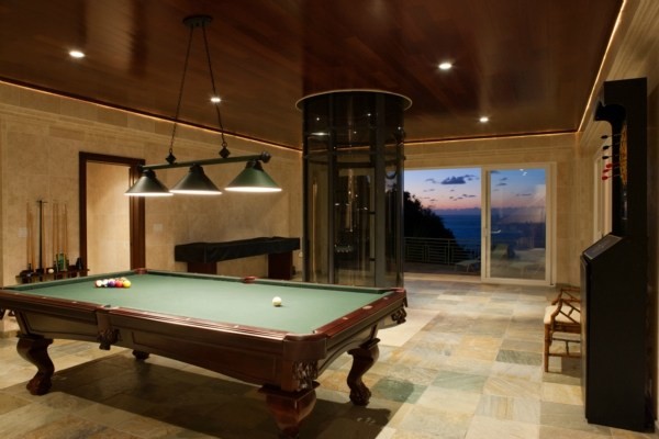 Inspiration for an expansive modern open concept family room in Hawaii with a game room, beige walls, travertine floors, no fireplace and no tv.