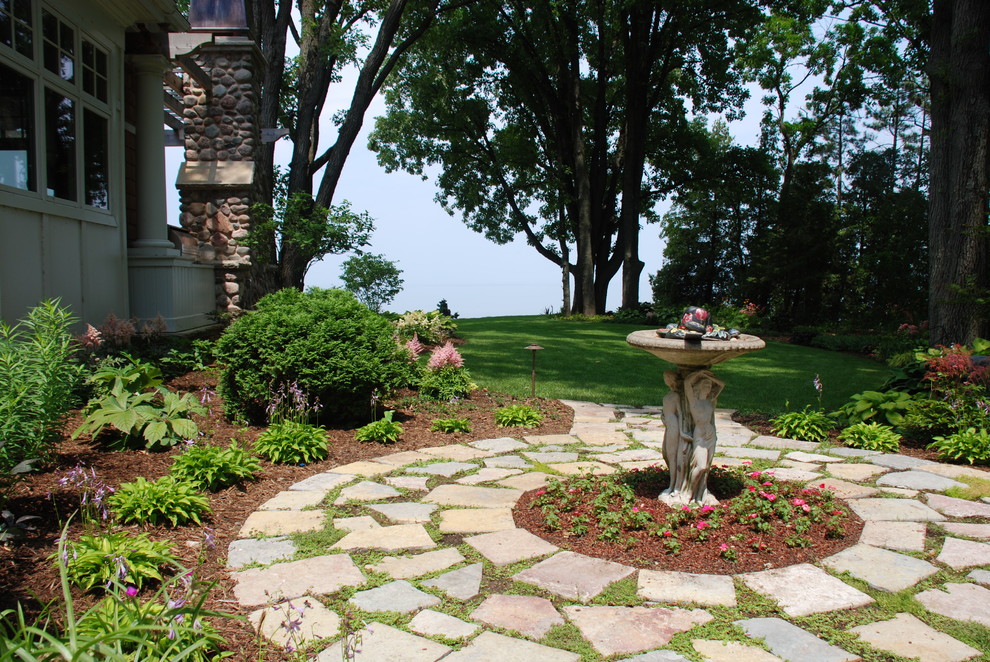 This is an example of a beach style backyard garden in Other with natural stone pavers.