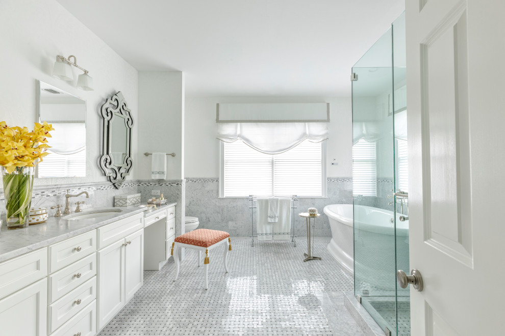 Inspiration for a french country master gray tile mosaic tile floor and white floor freestanding bathtub remodel in New York with recessed-panel cabinets, white cabinets, white walls, an undermount sink, a hinged shower door and gray countertops