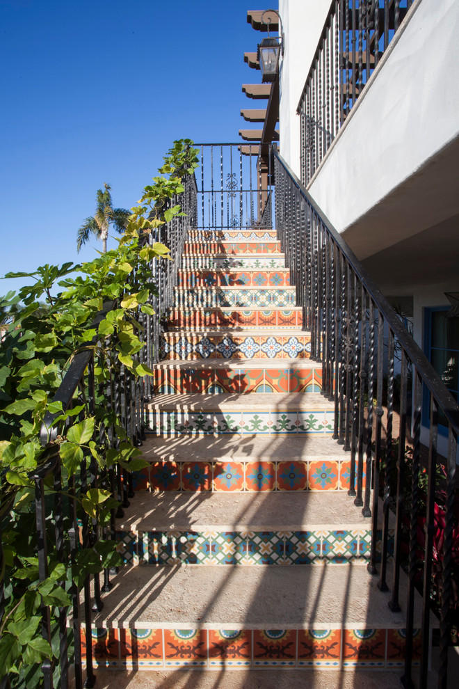 Mid-sized mediterranean concrete straight staircase in San Diego with tile risers.