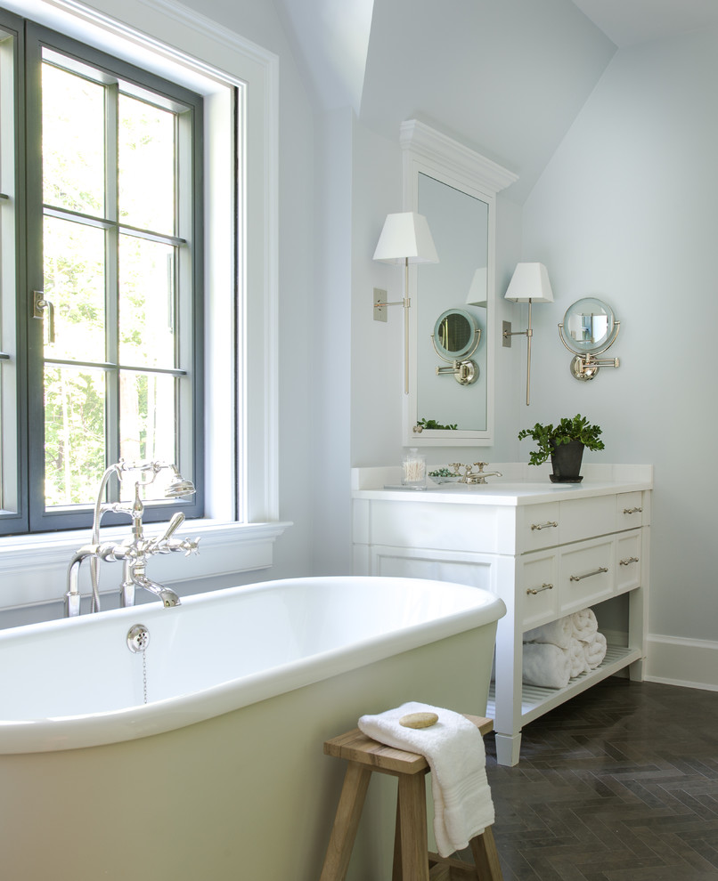 Transitional bathroom in Other with a freestanding tub and a console sink.