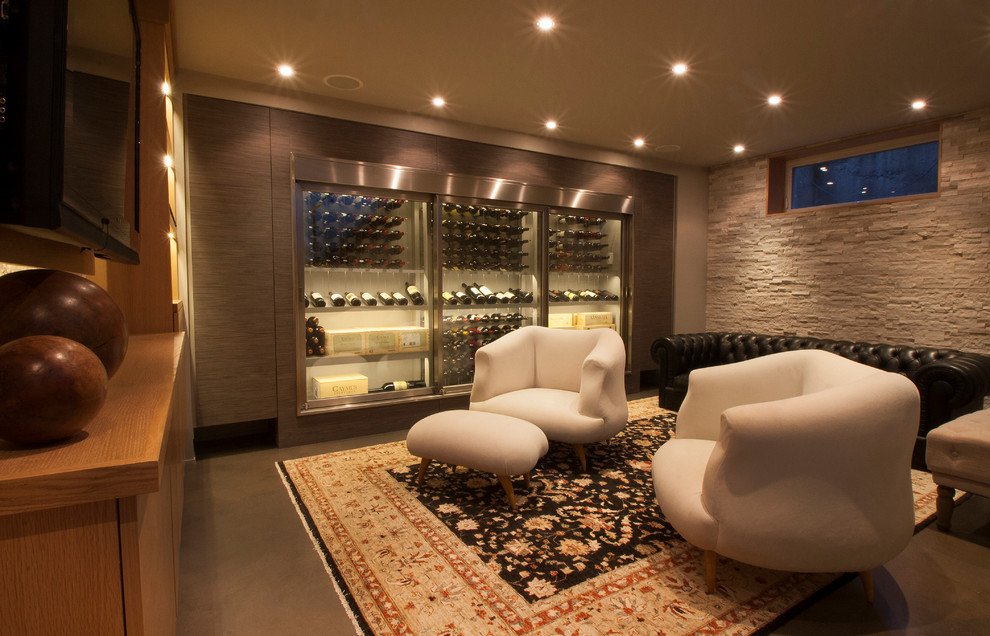 This is an example of a contemporary wine cellar in Toronto with storage racks.