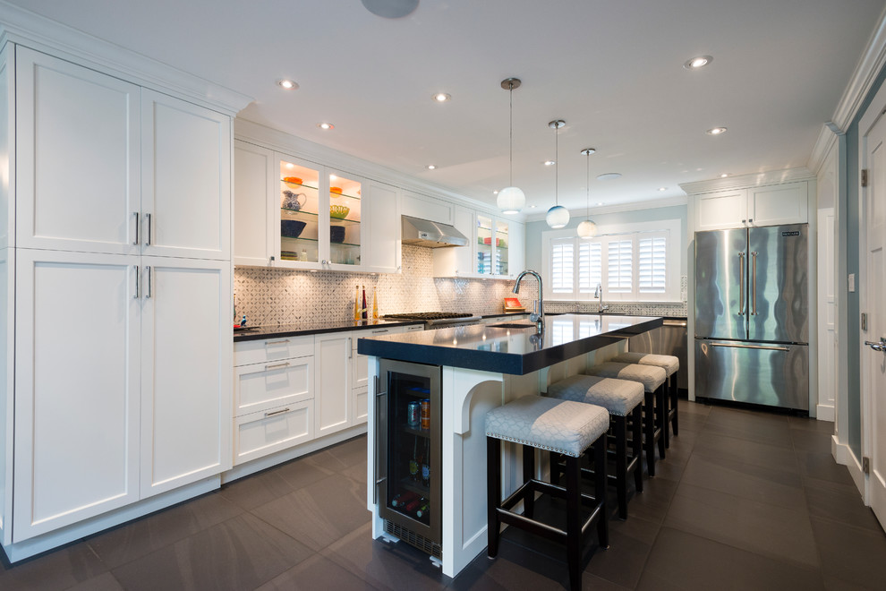 Inspiration for a large contemporary galley eat-in kitchen in Vancouver with an undermount sink, glass-front cabinets, white cabinets, granite benchtops, grey splashback, mosaic tile splashback, stainless steel appliances, ceramic floors and with island.