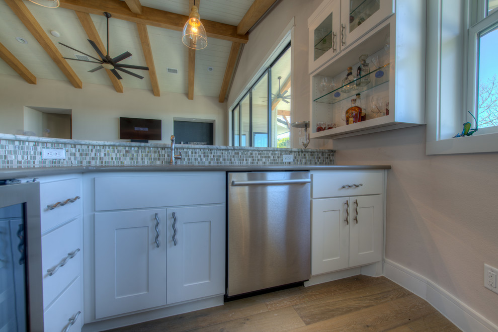 Example of a transitional eat-in kitchen design in Austin with stainless steel appliances and an island