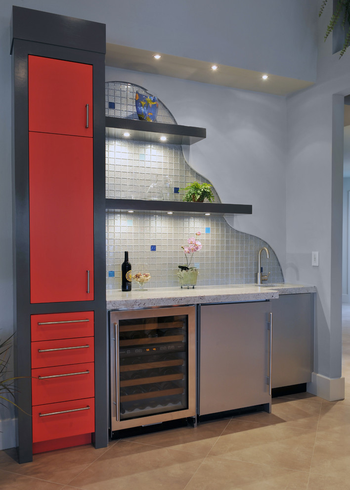 Design ideas for a contemporary single-wall wet bar in Miami with an undermount sink, flat-panel cabinets, red cabinets, granite benchtops, multi-coloured splashback, glass tile splashback, porcelain floors and beige floor.