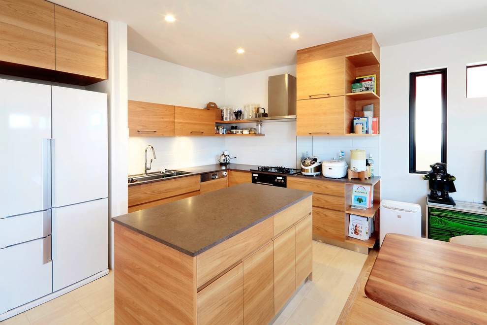 Contemporary l-shaped eat-in kitchen in Other with an undermount sink, flat-panel cabinets, medium wood cabinets, white splashback, black appliances, with island, beige floor and brown benchtop.